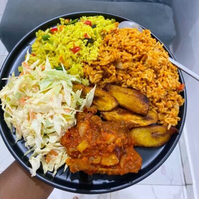 Jollof Rice and Fried Rice with Plantain, Salad, and Meat
